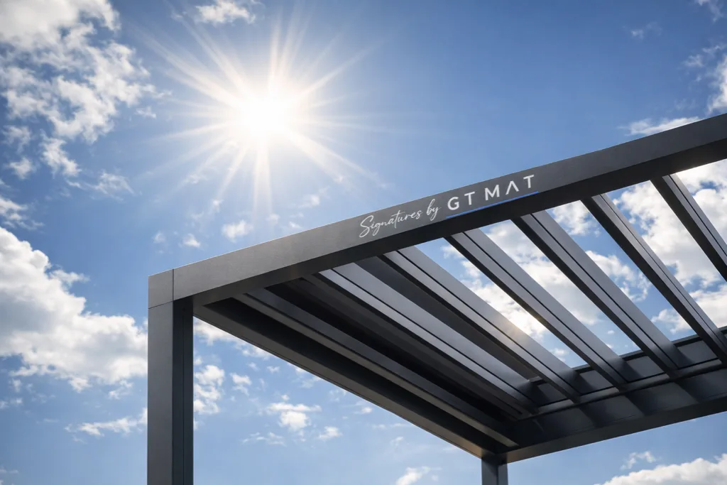 Pergola bioclimatique aluminium GT MAT vue en contre-plongée sous le ciel, installation en hauteur sur toit-terrasse aux Antilles